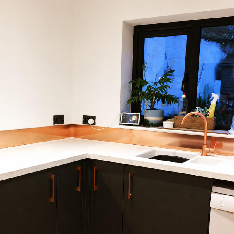 Kitchen with copper splashback, worktop trim and copper cabinet handles